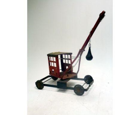 A vintage metal child's crane model, with operational winch. Some surface rusting.