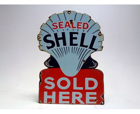 A scarce, single-sided, die-cut enamel sign - 'Sealed Shell Sold Here'. Depicts the early 'clamshell' type petrol pump globe 