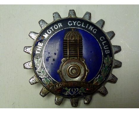 A 'sprocket' shaped car members badge, as would have been displayed by members of the Motorcycling Club. Features contrasting