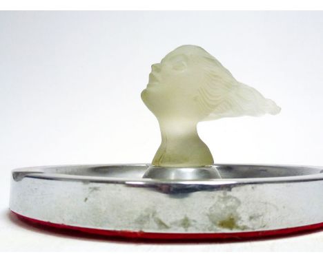In glass, by the Corning glass company, c1930s, good condition, save for a light nibble to one side, mounted to a period ciga