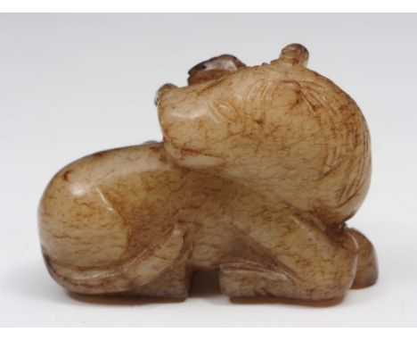 A Chinese grey green and brown striated jade horse and monkey Ming dynasty (1368-1644) the horse's head turned right back ove