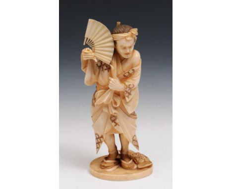 A Japense ivory okimono of a farmer Meiji period signed Norimitsu, the farmer holding an open fan and standing next to an ope