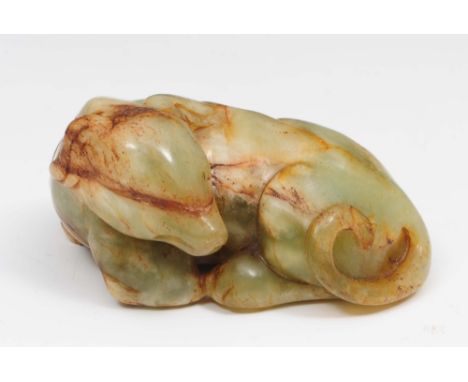 A Chinese mottled pale green jade hound 17th/18th Century recumbent with head turned to one side, 7cm long Part of and Englis