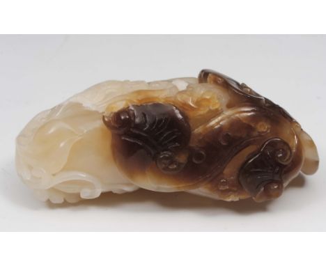 A Chinese white and brown jade ling chih 18th Century carved with vines and leaves, 6.5cm long