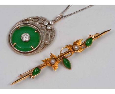 A Chinese jade and diamond pendant and a jade brooch the pendant mounted on a white metal chain, largest diamond being 1/2 ca