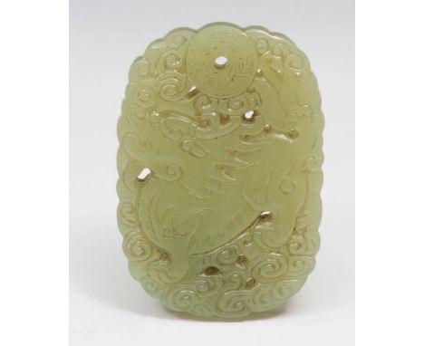A Chinese yellowish green jade pendant 18th Century carved and pierced with a dragon and a bi with four characters, 5.9cm lon