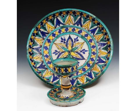 A  Moroccan pottery polychrome candlestick late 19th/20th Century 14cm and a similar Moroccan shallow dish 31cm (2)