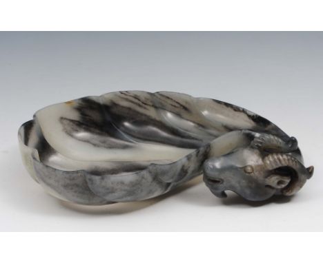 A Chinese carved black and white jade cup 18th Century in the form of a Hindustani ram head, 14cm long