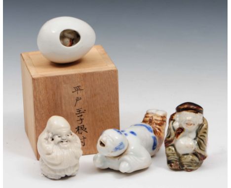 A Japanese blue and white Hirado porcelain netsuke 19th century depicting a laughing youth, anouther white glazed example of 