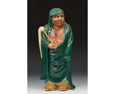 A Japanese Kutani model of Daruma late 19th Century the bearded figure having a green glazed cloak and hood, 44cm high