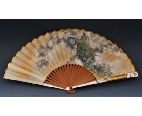 A Japanese paper fan 1880-1900 painted with peacocks and a view of Mount Fuji, mounted on bamboo sticks and ivory exterior, d