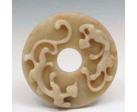 A Chinese greyish white jade bi disc Chou style, carved in relief with two chih ling to the front, reverse with allover nippl