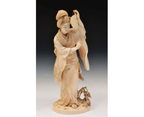 A Japanese carved ivory okimono of a standing Geisha Meiji period by Kaigyokusai Masatsugu, signed, the Geisha holding a fan 