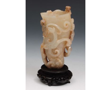 A Chinese jade wrythen cup Han dynasty the cup having raised chiling dragons and with engraved decoration, on a later hardwoo