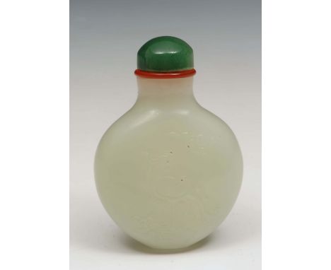 A Chinese mutton fat jade ovoid snuff bottle 1800-1850 carved in low relief with phoenix perched on a rock with fungus plant 