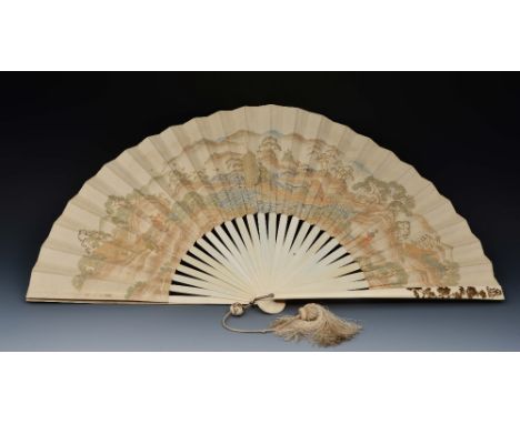 A Japanese ivory and paper fan Meiji period painted in gold and colours showing fishermen on a boat in a landscape, one is Da