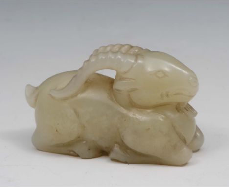 A Chinese carved white jade ram 18th/19th Century in the Sung style, in a recumbent stance, 4.8cm long