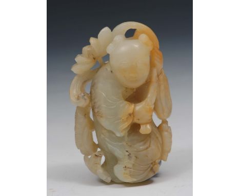 A Chinese pale celadon jade figure of a boy 17th/18th Century the boy standing holing a flowering lotus branch over his left 