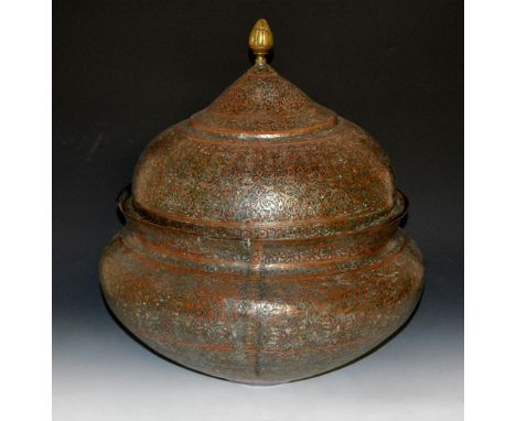 An Indo/Persian tinned copper large bowl and cover 19th/20th Century allover engraved arabesques with brass finial, 52cm high