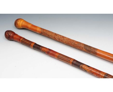 A Japanese carved bamboo walking stick 19th/20th Century carved with birds among reeds, signed and inscribed, 89cm high, and 