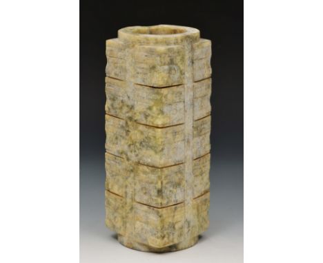 A Chinese archaistic nephrite jade Cong Qing dynasty or earlier of five tiered form with mask to each corner, 23cm high Prove
