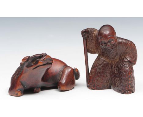 Two wood netsuke Meiji period one modelled as Gyoja, 3.5cm high, the other as a shi-shi, 4cm across