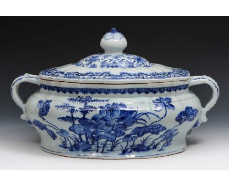 A Chinese blue and white porcelain soup tureen and cover circa 1740 the sides decorated with lotus flowers and bamboo within 