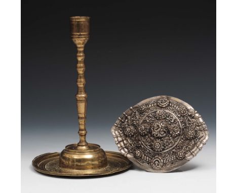 An ottoman brass engraved candlestick 19th Century 26cm and a silver metal oval foliate large belt buckle 18cm (2)