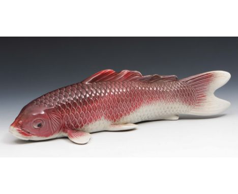 A Japanese ceramic carp okimono Taisho Period (early 20th Century) signed, with a purple pinkish glaze, 37cm long