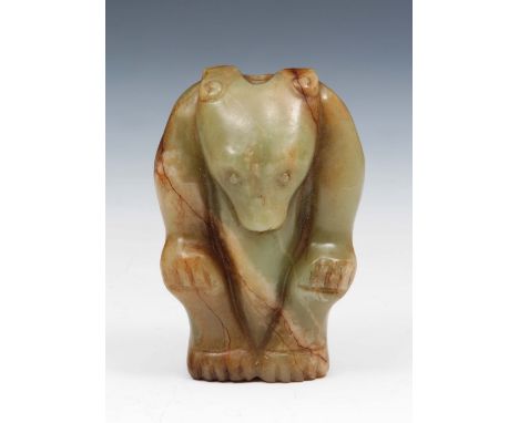 A Chinese carved celadon jade bear probably Ming dynasty standing with his front paws on his knees, 7cm high