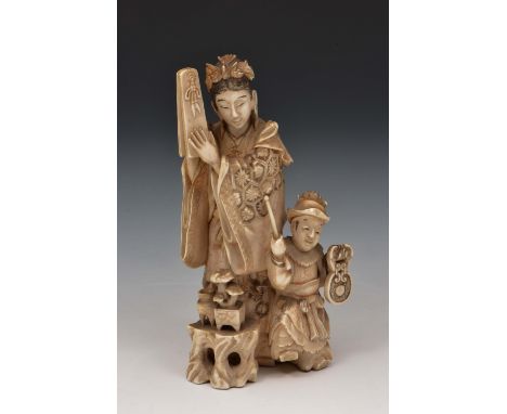 A Japanese carved ivory okimono of the Goddess Benten 19th Century Benten standing playing a castanet style musical instrumen