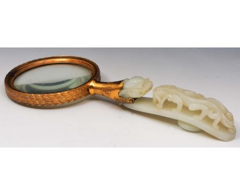 A Chinese white jade hook 18th Century mounted as a magnifying glass with silver gilt leaf decorated border marked Bensabott,