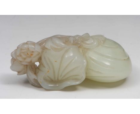 A Chinese white and russet jade group 18th/19th Century showing a monkey climbing a rock with lotus flowers, 7.4cm long