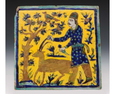 A Qajar yellow ground tile circa 1900 with huntsman and stag, 23cm across