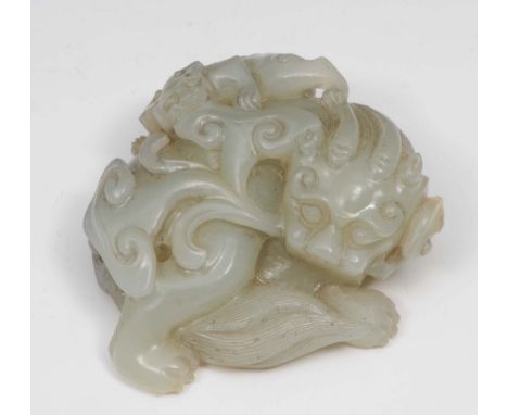 A Chinese white jade carving of a horned beast 18th Century the beast curled looking over his shoulder, with a lingzhi on his
