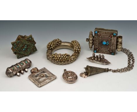 A collection of Tibetan, Islamic & Indian silver metal jewellery 19th/20th Century to include a scroll holder, a bangle and o