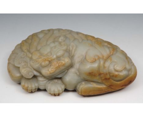 A Chinese grey green jade boulder  17th/18th Century carved as a recumbent kylin, his head resting upon its front legs and ho