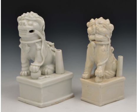 Two Chinese blanc de chine Buddhistic lions 17th Century each modelled as a taper stick, 14cm and 13cm