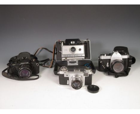 A Contax 35mm Camera with 2/50 Zeiss-Opton Lens, two Pentax 35mm Cameras and a Polaroid 355 automatic Land Camera 