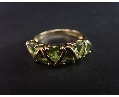 A Peridot Ring claw-set six triangular-cut stones in 9ct gold, ring size R 