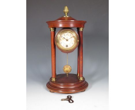 An Empire style portico Mantel Clock with gilt acorn finial, the circular dial decorated floral swags (dial stained), on circ