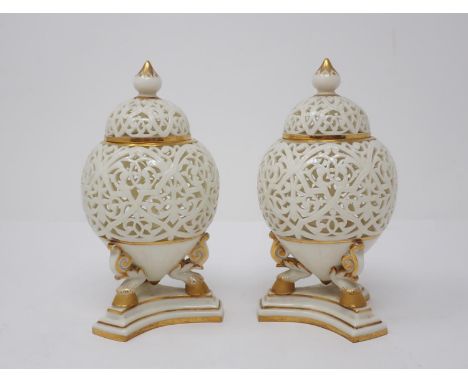 A pair of Grainger &amp; Co. Worcester reticulated Vases and Covers, C.1870's, the tapering bulbous bodies raised on three ho