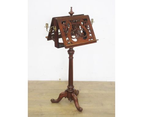 A 19th Century walnut double-sided adjustable Music Stand with pierced fret carving in the form of a lyre to each side and mo