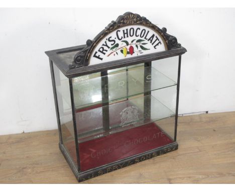 A late 19th or early 20th Century Fry's Chocolate glazed Display Cabinet with arched surmount decorated with gilt trailing le