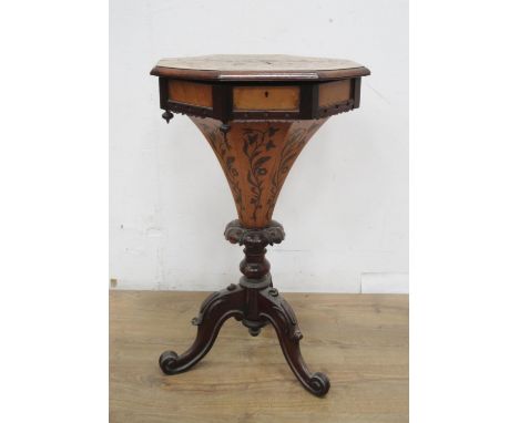 A Victorian Sewing Table with marquetry inlay having octagonal hinged top enclosing fitted compartments, tapering to a tripod