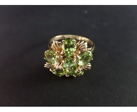 A flowerhead Peridot Ring claw-set six oval-cut stones in 9ct gold, ring size S 