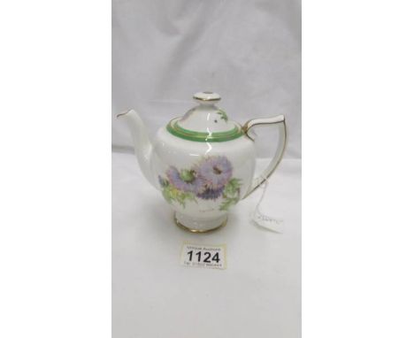 A Royal Doulton teapot for one person, 4.5" tall.  Bone china, decorated on each side by P Curnock with the 'Glamis Thistle',