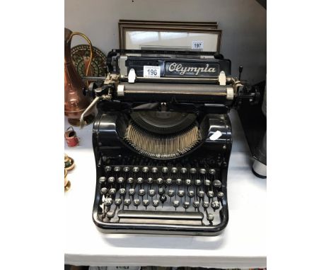 An Olympia typewriter ****Condition report**** This is a model 8. Chipping to black enamel in places. Keys &amp; buttons will