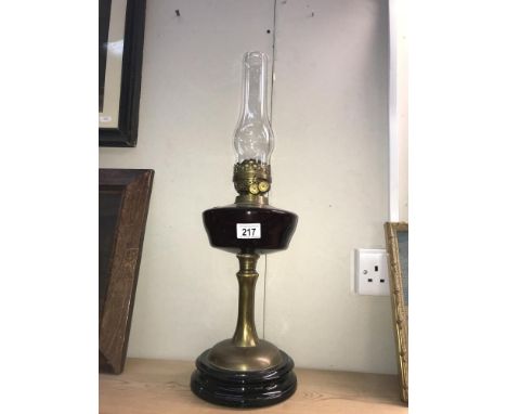 A Victorian oil lamp with brass column &amp; glass font