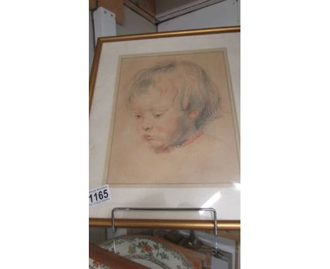 A framed and glazed pastel portrait of a young child.